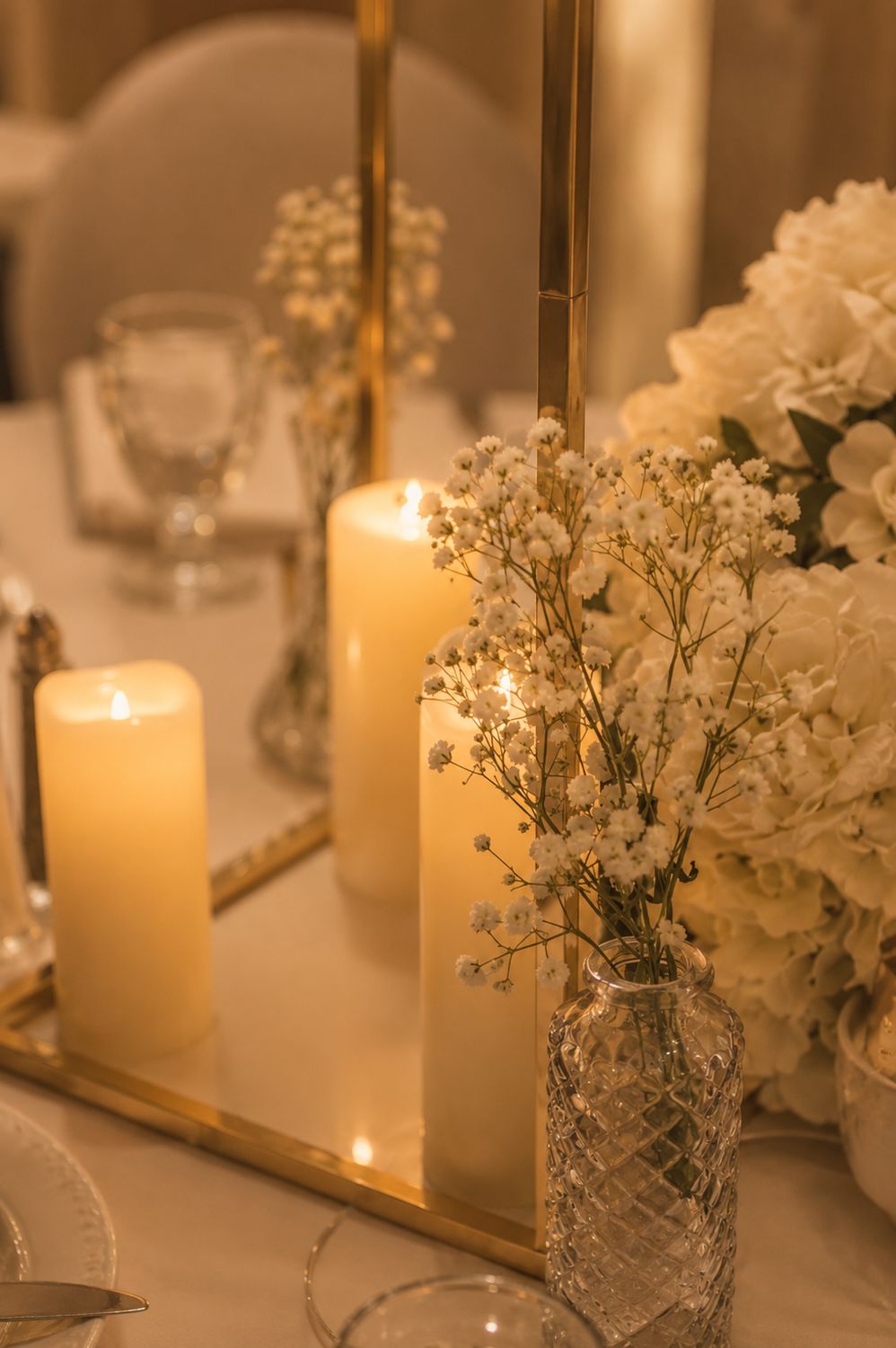 Candlelit centrepiece on a set banquet table
